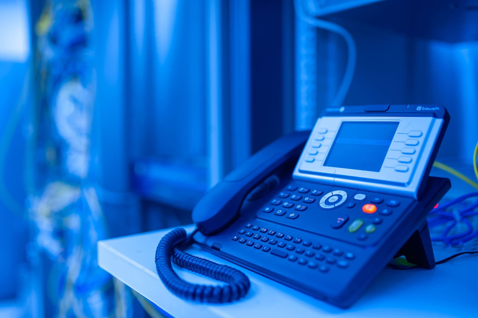 IP desk telephone in a corporate communications room